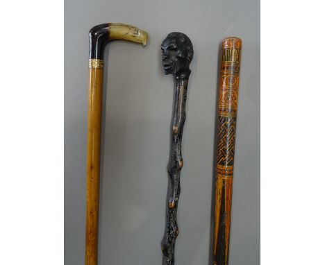 An unusual polychrome painted wooden walking stick, late 19th century, possibly Persian (98cm), a horn and brass inlaid 'eagl