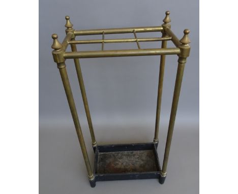 An Edwardian tubular brass six division stick stand on a rectangular cast iron base, 64cm high.