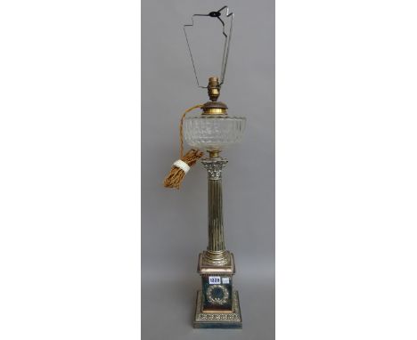 A silver plated and glass mounted oil lamp (converted) late 19th century, of Corinthian column form with facet cut clear glas