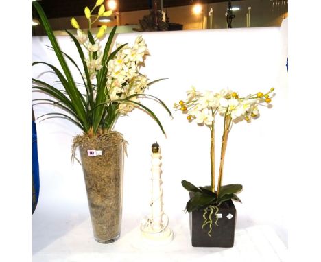 A faux orchid in tapering glass vase, another faux plant and a cream painted table lamp (3).  S2B