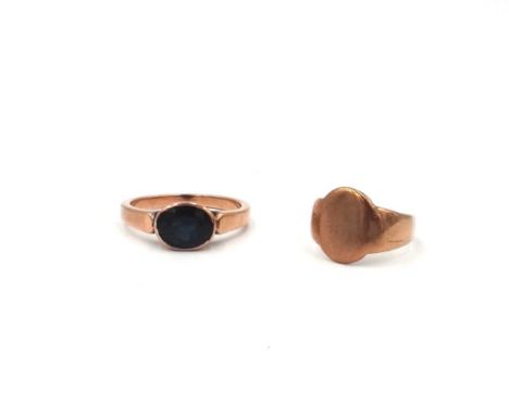 A gold and sapphire single stone ring, collet set with an oval cut sapphire, ring size T and a half and a gold signet ring, r