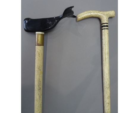 A horn and whalebone walking stick, 19th century, the handle carved as a whale, (93cm) and one further whalebone walking stic