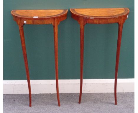 A pair of late 18th/ early 19th century Continental satinwood and fruitwood demi-lune console tables, each on splayed turned 