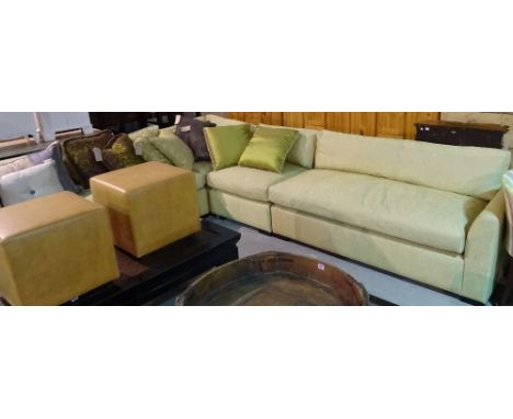 A 20th century hardwood framed corner sofa on square block supports, with green upholstery, 250cm wide.