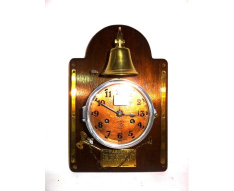 A 20th century 8 day brass porthole clock, 'Lord Kelvin Ltd', mounted on mahogany board with brass belt. 