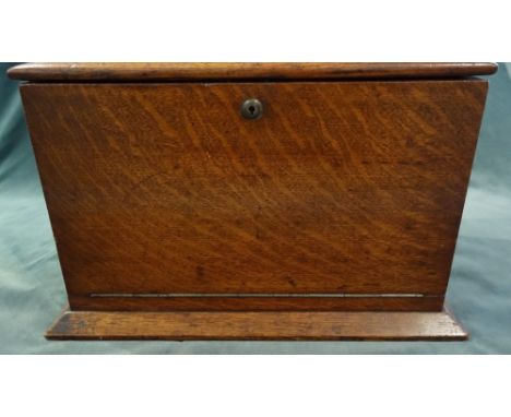 'Army & Navy CSI Makers'; an early 20th century oak travelling writing box, the lift top and fold-out front revealing a fitte
