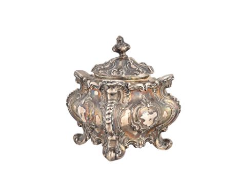 A late Victorian silver tea caddy of rococo bombe form, with a pull off lid, with scrolling decoration raised on four splayed