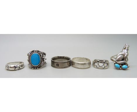 Five silver rings and one titanium ring, including one Navajo Running Bear Trading Gallup size R