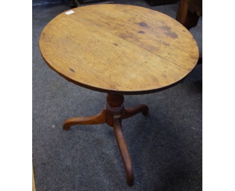 A George III oak tripod table, circular top, turned column, circa 1830. 68cm high x 63cm diameter.