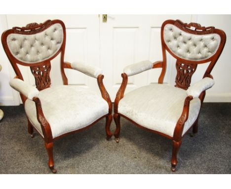 A pair of Hepplewhite style open armchairs, shaped button upholstered back, padded arms and seat, French cabriole forelegs.