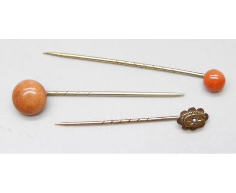 Three stick pins including a 9ct gold topped seed pearl set example, with two vintage jewellery boxes