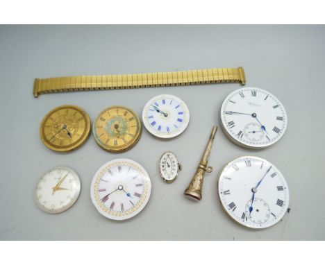 A collection of watch movements including a Waltham example and Swiss, and an unmarked watch key