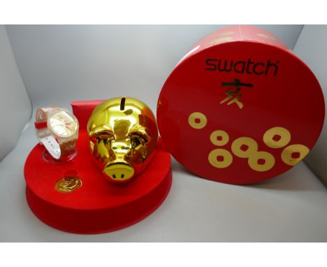 A 2007 Swatch Chinese Year of The Pig Collector's Watch Set, boxed and with piggy bank and token