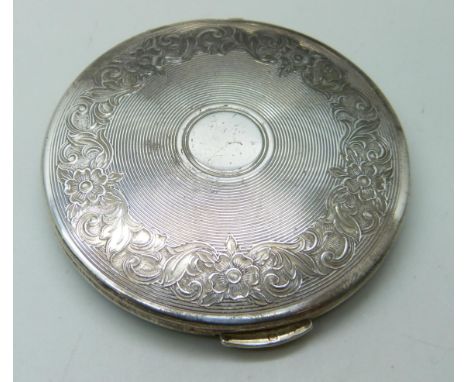A silver compact with engine turned design and floral decoration, London, 1960, 68g