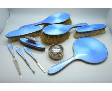 A silver Art Deco guilloche blue enamel dressing table and vanity set including brushes and a hand mirror, Birmingham, 1925, 