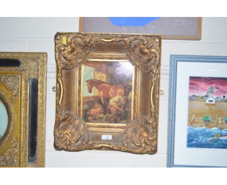 An ornate gilt framed oleograph of a blacksmith