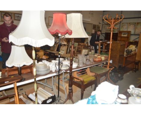 A wrought iron standard lamp and shade; and a wooden standard lamp