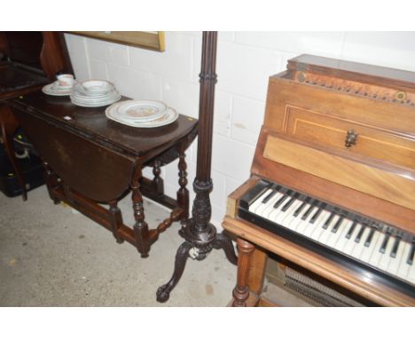 An ornately carved mahogany standard lamp with white metal shield shaped presentation plaque