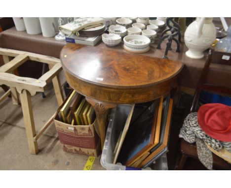 A walnut fold over card table raised on cabriole supports and pad feet