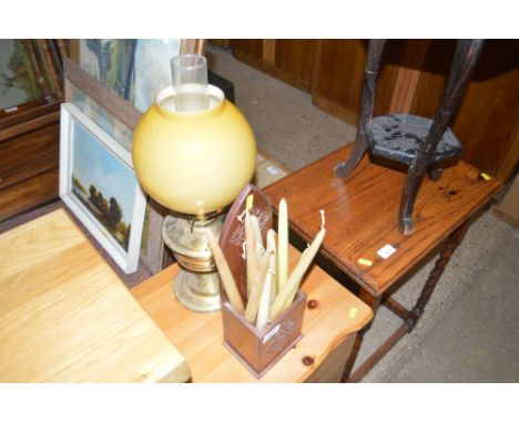 A carved hardwood candle box and a brass oil lamp 