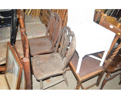 A pair of elm seated stick and wheel back kitchen chairs