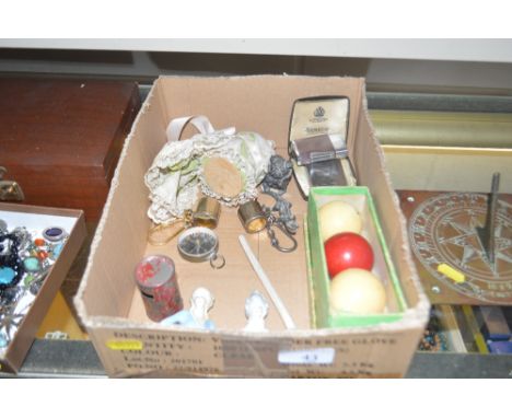 A box containing three china half pin dolls, two lighters, an old clay pipe, a compass etc. 