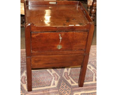 A George III mahogany tray top commode, late 18th century, the gallery top with three apertures as carrying handles, above a 
