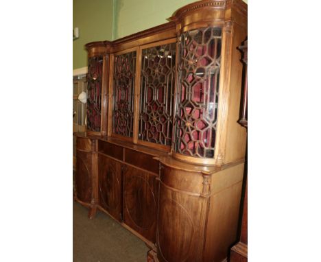 A George III breakfront bookcase, the moulded and dentil cornice above two glazed doors flanked by two bowfront doors, all be