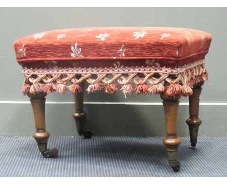 Stamped "BULSTRODE CAMBRIDGE" a walnut stool on turned and tapering legs with ceramic castors, 45 x 58 x 46cm