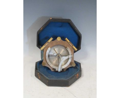 A lacquered brass surveying compass with levels and gnomon, cased