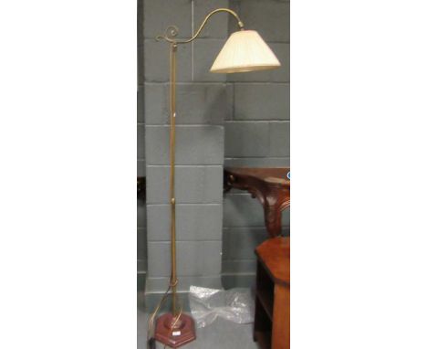 A brass floor lamp on a wooden plinth, 167cm