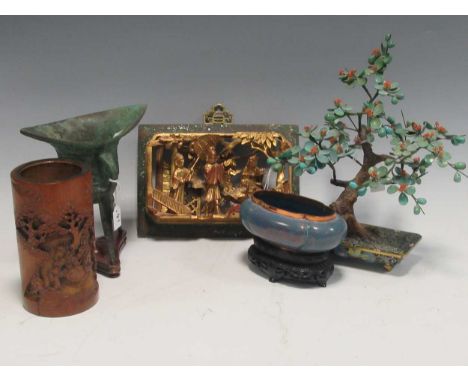 A reproduction Chinese archaic style tripod cup, a modern simulated bonzai tree with enameled stand, a gilt and pierced wood 