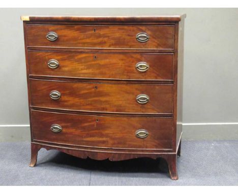 An early 19th century figured mahogany bowfront chest of four long drawers with fretted apron on slender bracket feet (some d