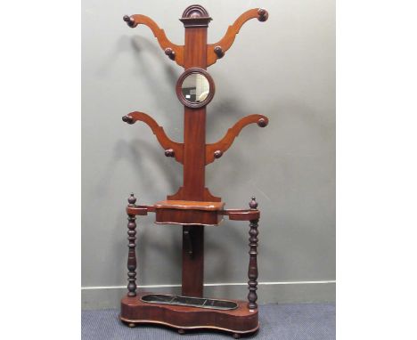 A Victorian mahogany hall stand with scroll arms and central mirror with a three partition stick stand to the base, approx 19