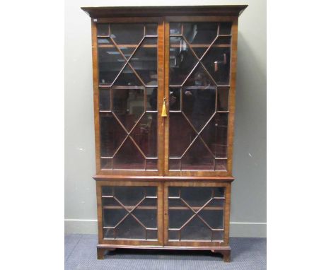 A 19th Century mahogany bookcase enclosed by two pairs of glazed doors on bracket feet, 201 x 121 x 39cm