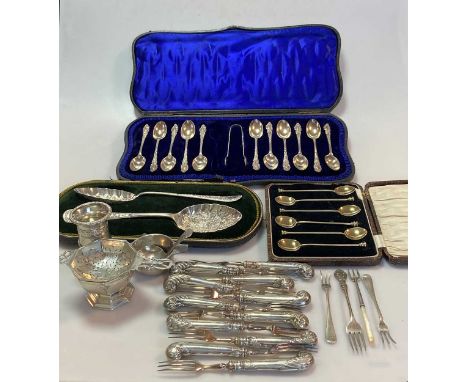 A collection of silver flatware including a cased set of 6 teaspoons, a cased set of 11 teaspoons and tongs, a cased pair of 