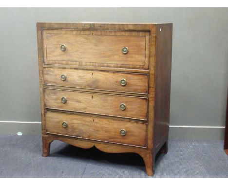 An early 19th century mahogany secetaire, the secretaire drawer fitted with drawers and pidgeon holes over three long graduat