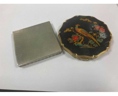 A silver compact and another enamelled brass example (2)