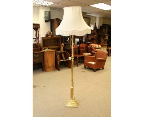 A brass standard lamp and shade