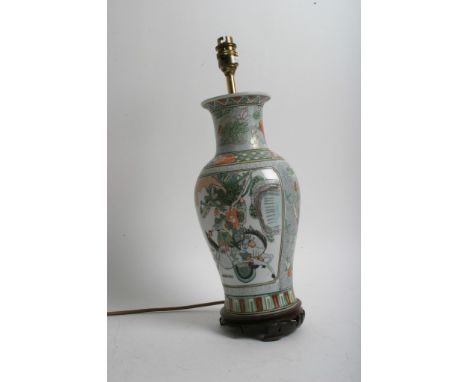A Chinese famille verte vase converted to a table lamp, decorated with warriors on horseback with applied wooden stand a/f st