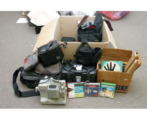 An old film projector and box of empty camera cases