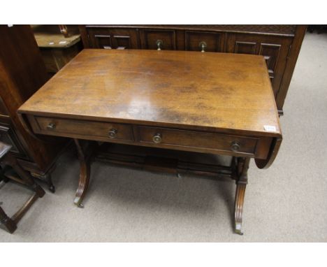 A mahogany sofa table fitted with two drawers and twin flap having stretcher base