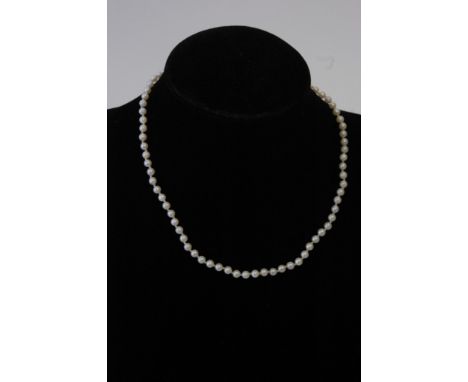 A single strand cultured pearl necklace with a gold clasp