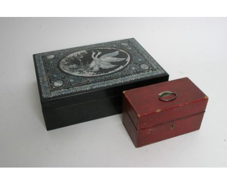 A lacquer box inset with mother of pearl depicting two cranes in flight together with a small leather box with three tin line