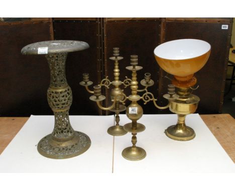 An oil lamp, brass candlestick and stand