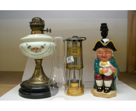 A miners lamp, a Toby Jug lamp and a hand painted oil lamp