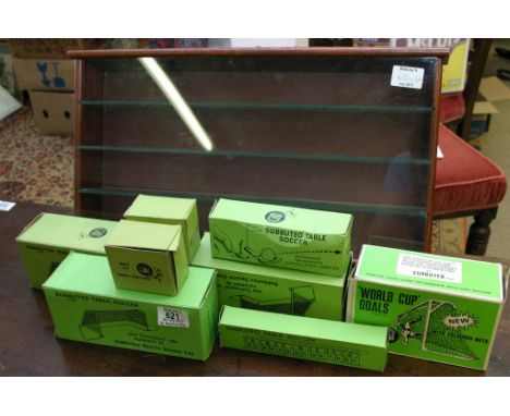 A collection of boxed Subbuteo accessories with a wooden display case