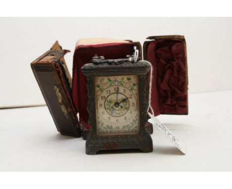 A miniature leather cased carriage clock with floral decorated dial