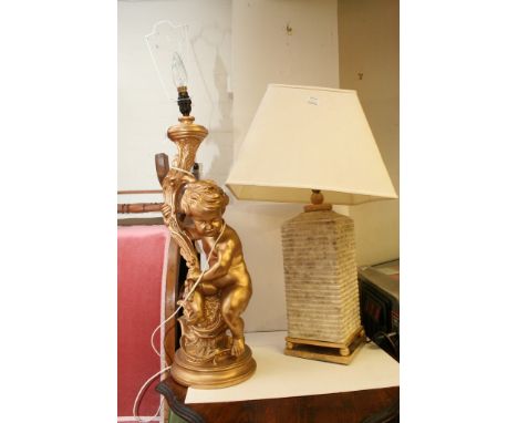 A large plaster lamp formed as a cherub and one other lamp