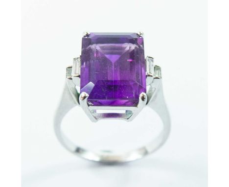 the rectangular cut cornered amethyst measuring 14mm x 10mm, flanked by four graduated baguette diamonds, stamped 750, size O